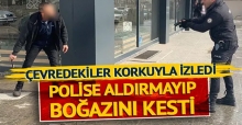 Çevredekiler korkuyla izledi, polise aldırmayıp boğazını kesti